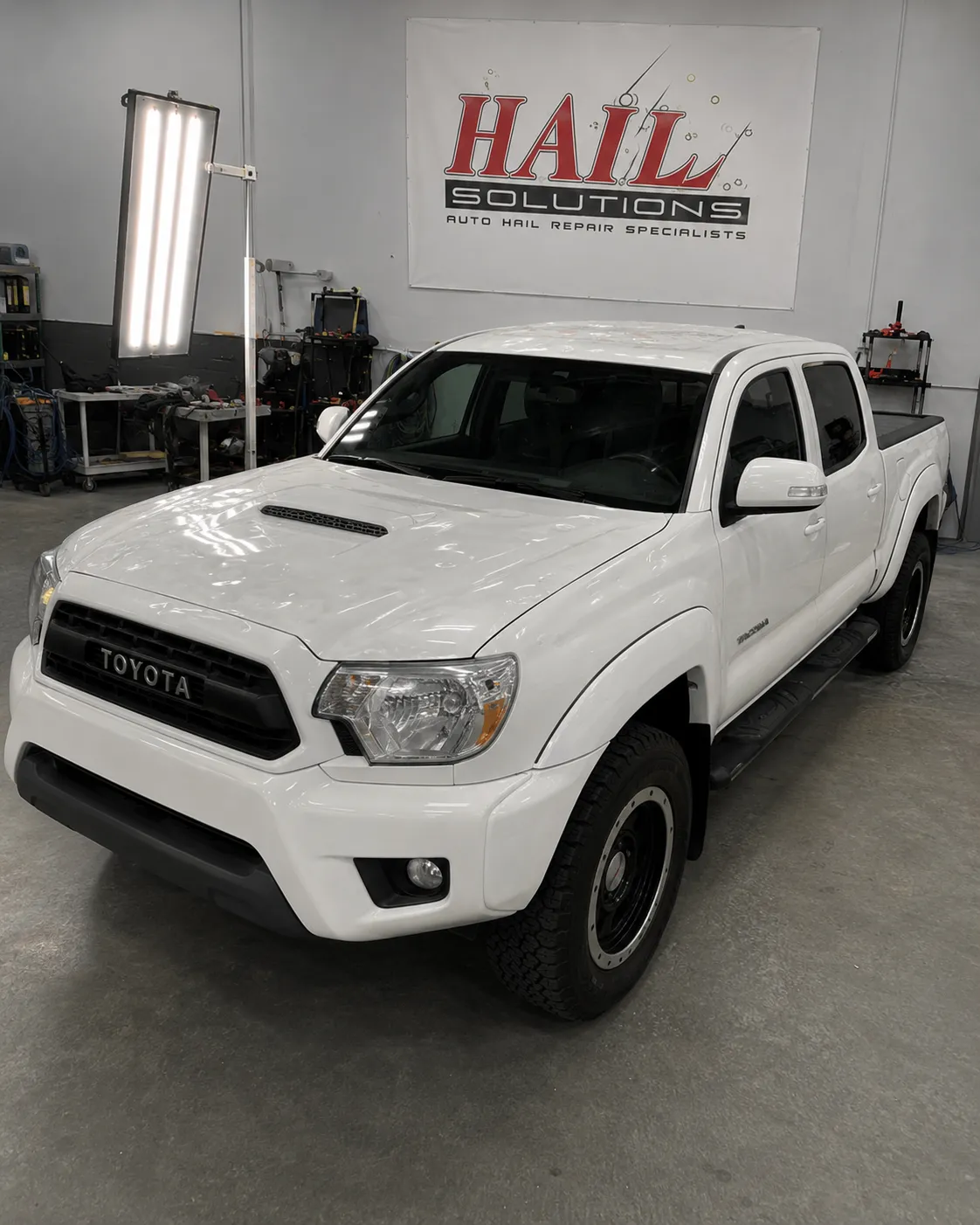Detail photo of 2015 Toyota Tacoma — Super White hail damage repair in Raytown, MO