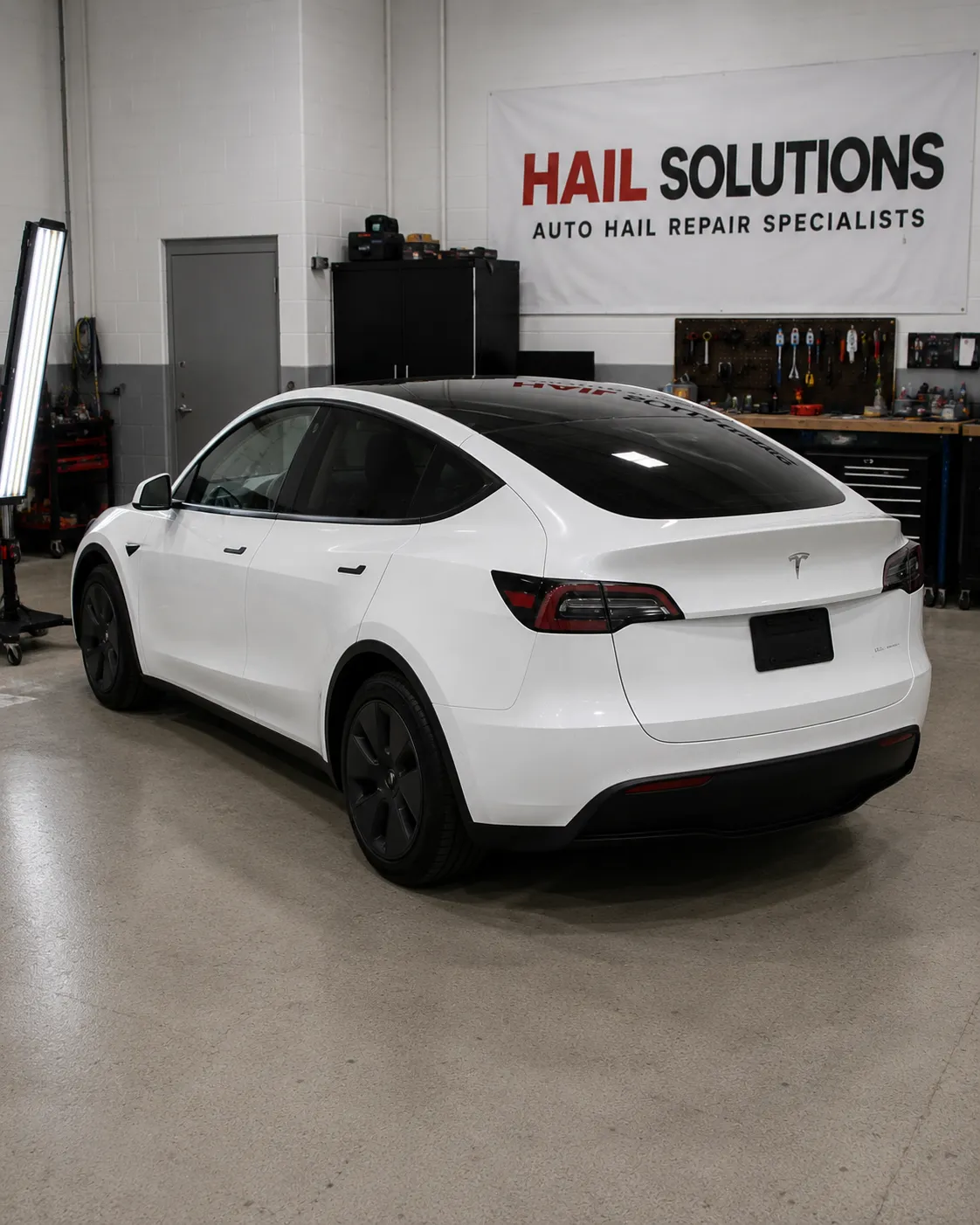 Detail photo of 2022 Tesla Model Y — Pearl White Multi-Coat hail damage repair in Leawood, KS